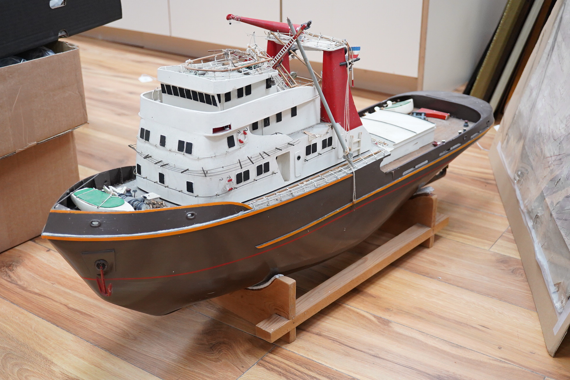 A model of the tugboat Amsterdam, probably built from a kit as a pond yacht, and powered by an electric motor, length of hull approx 103cm, of primarily painted wood construction